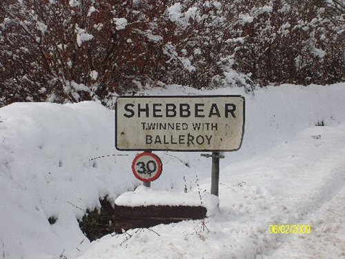 Shebbear village sign in snow